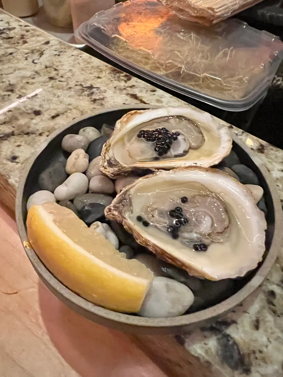 Oysters, sashimi and two other dishes photographed in downtown Toronto.